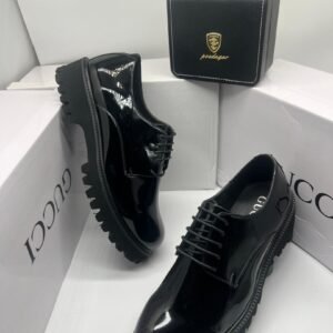 Black Gucci men's shoe with a sleek design, featuring polished leather and subtle detailing